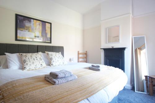 a bedroom with a bed with towels on it at Handbridge House in Chester