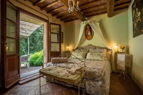 a bedroom with a bed and a large window at Pian Delle More in Sassetta