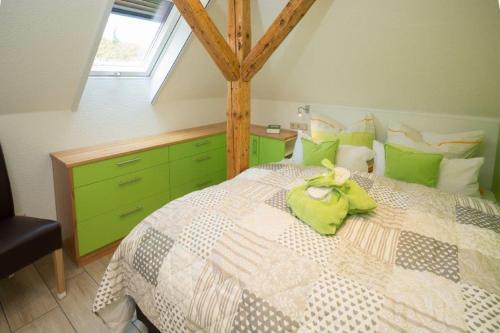 um quarto com uma cama com armários verdes e uma janela em Ferienwohnung Harztraum em Bad Sachsa