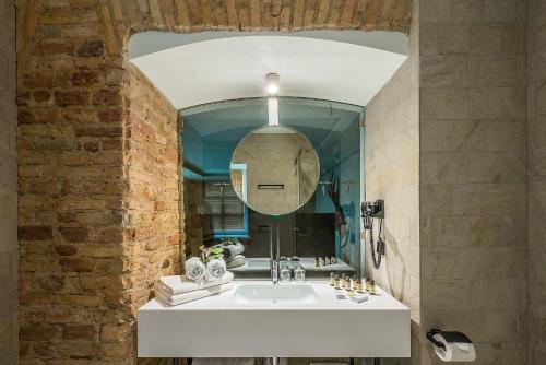 
a bathroom with a sink and a mirror at Artagonist Art Hotel in Vilnius
