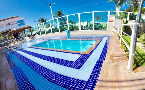 a swimming pool with blue tiles on a building at FPH Hotel in Aracaju