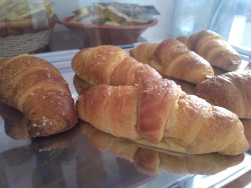 a plate of croissants and other pastries on a table at B&B Casa Alessio in Santa Domenica