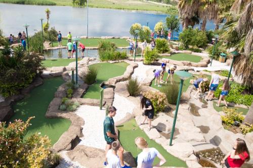 a group of people playing golf in a golf course at Umuzi Lodge in Secunda