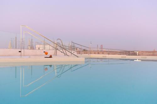 a pool of water with a ramp to the side at Hotel Macià Sevilla Kubb in Seville