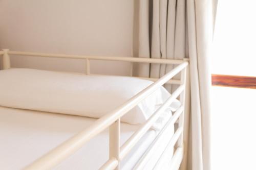 a white bunk bed in a room at Casa Grande Surf Hostel in El Médano