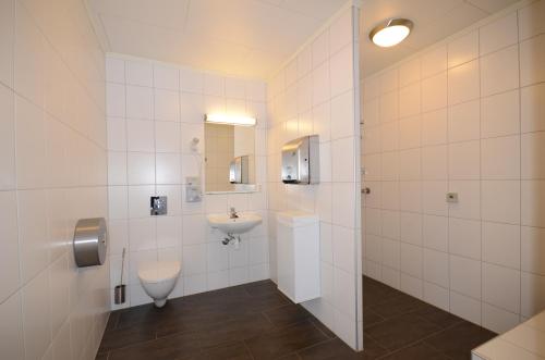 a white bathroom with a sink and a toilet at Fagernes Camping in Fagernes