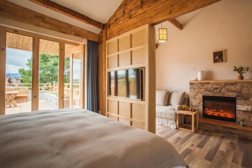 a bedroom with a bed and a fireplace at Eden Court in Lijiang