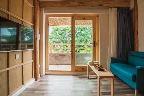 a living room with a blue couch and a table at Eden Court in Lijiang