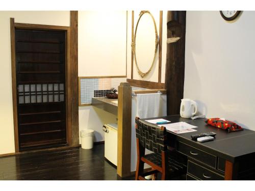 a kitchen with a counter and a table with chairs at Kotohira Guest House en in Hita