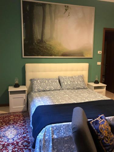 a bedroom with a bed with a painting on the wall at Residence Griffoni in Bologna