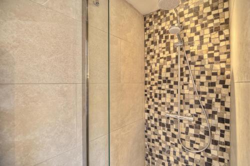 a bathroom with a shower with a glass door at Le Refuge - Gigaro Lodges in La Croix-Valmer