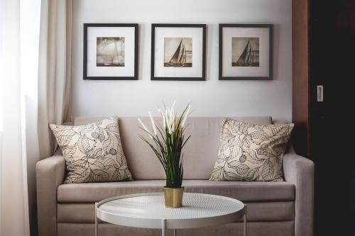 a living room with a couch and a table at Satori Hotel in Haifa