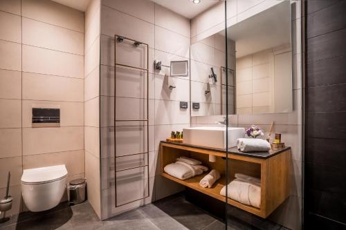a bathroom with a sink and a shower at Kedem Hotel - Adults Only in Tirat Karmel