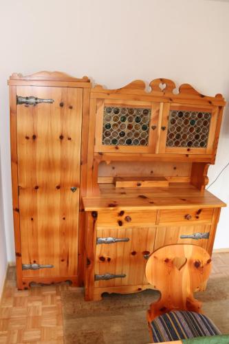 a wooden cabinet with drawers and a wooden chair at Hotel & Hostel Sandwirt in Bad Ischl