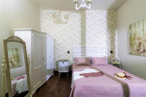 a bedroom with a pink bed and a mirror at Chandax luxury villa in Heraklio Town