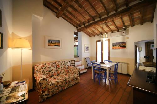 a living room with a couch and a table at Fabio Apartments San Gimignano in San Gimignano