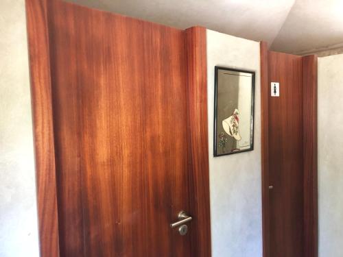 a wooden door in a room with a picture on it at Chambre de la tour - Quinta da Prelada Simão in Celorico de Basto