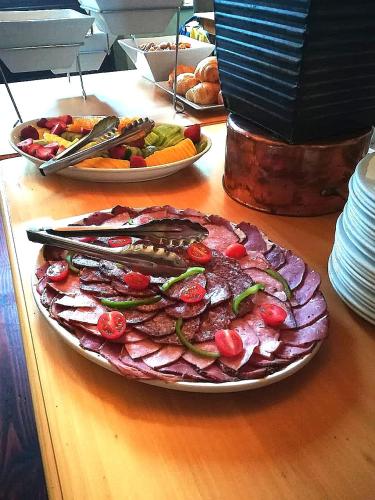 a plate of meat and vegetables on a table at Zevenwacht Country Inn in Kuilsrivier