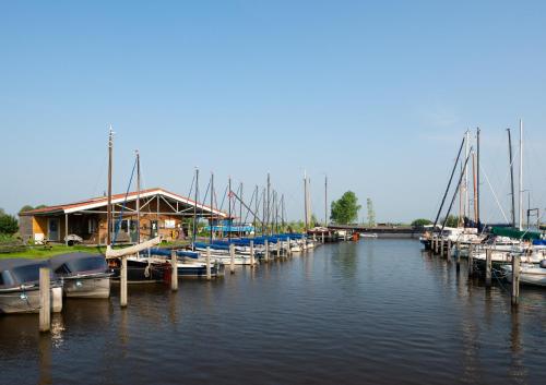 a group of boats docked at a marina at Rufus aan het water in Broek