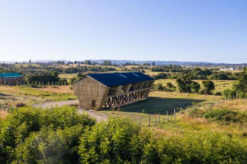 an aerial view of a building in a field at Cabaña Eco Loft Chiloe Chonchi in Chonchi