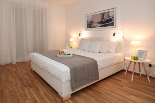 a bedroom with a bed with a tray of food on it at Lunas Appartements Essen in Essen
