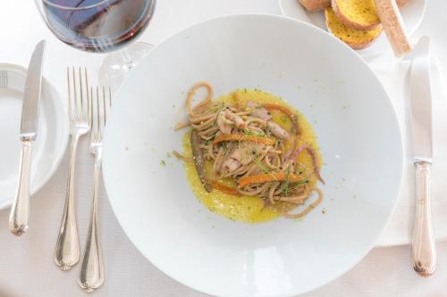 a white plate of food on a table at Bettoja Hotel Mediterraneo in Rome