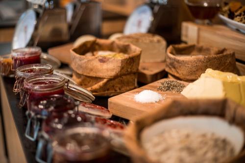 a table topped with lots of different types of food at Kedem Hotel - Adults Only in Tirat Karmel