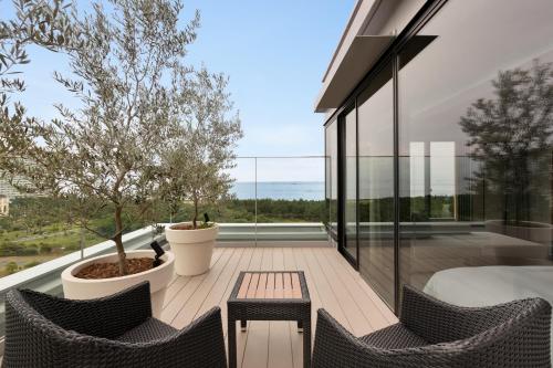 a patio with two chairs and a table on a balcony at Hyatt Regency Tokyo Bay in Urayasu