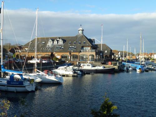 a group of boats are docked in a marina at Boathouse Hotel in Hythe
