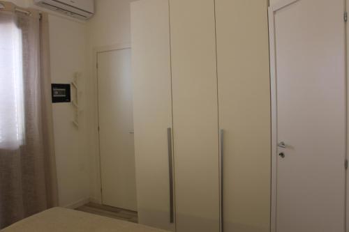 a glass cabinet in a room with a door at Lanterna sul mare in Favignana