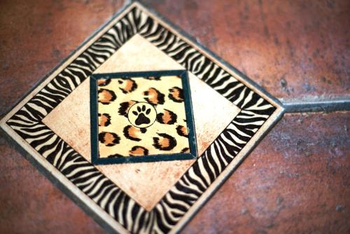 a wooden floor with a cheetah pattern on it at Premier Resort Mpongo Private Game Reserve in Macleantown