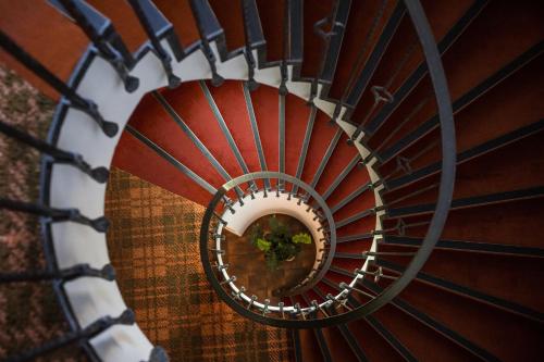 a spiral staircase with a mirror in the middle at Pension Sankt Urban in Merano