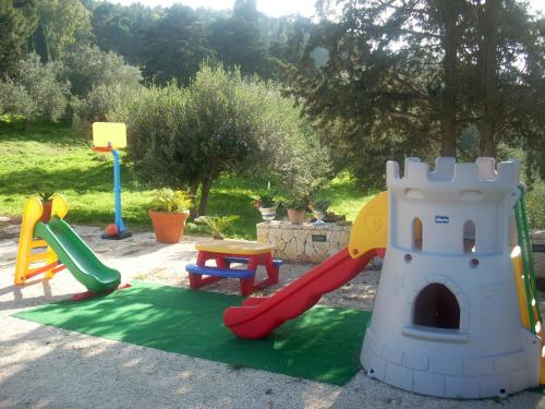 a playground with a slide and a toy castle at Turismo Rurale Baglio Fastuchera in Alcamo