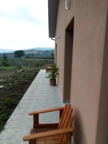 two benches sitting on a walkway next to a building at Rupe delle sorbe in Atella