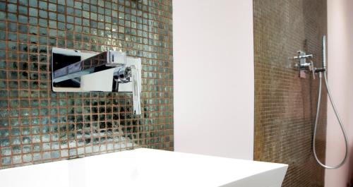 a bathroom with a shower with a faucet at CAB Ap'art in Luxembourg