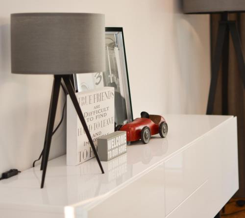 a table with a lamp and a toy car on it at Lunas Appartements Essen in Essen