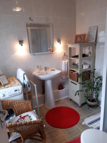 a bathroom with a sink and a table and a shelf at Les Alouettes B&B in Hardecourt-aux-Bois