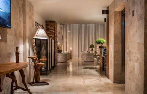 a hallway with a lobby with a table and chairs at Kedem Hotel - Adults Only in Tirat Karmel