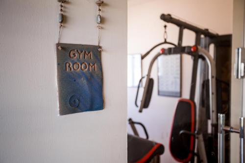 a sign that says gym room hanging on a bus at Satori Hotel in Haifa