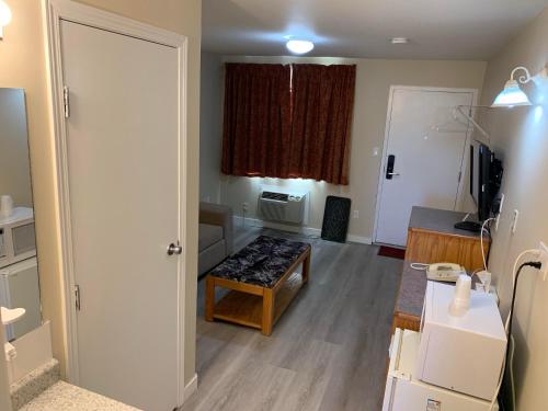 a living room with a couch and a table at Red Deer Inn & Suites in Red Deer