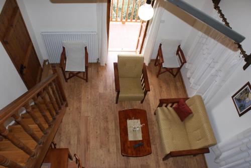 an overhead view of a living room with chairs and a table at ATRATSA Mountain Suites in Kalopanayiotis