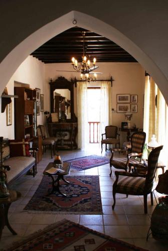 a large living room with an archway in a house at ATRATSA Mountain Suites in Kalopanayiotis