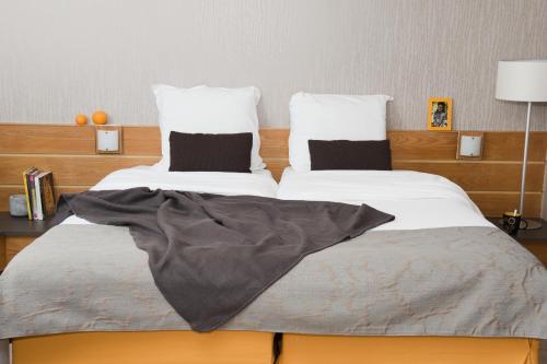 a bedroom with two beds with pillows on it at Aparthotel Adagio Paris XV in Paris