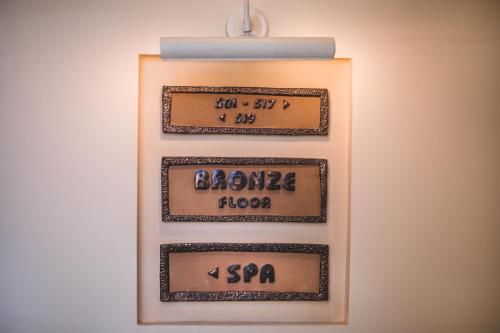 a clock hanging on a wall with the elapsed time at Satori Hotel in Haifa