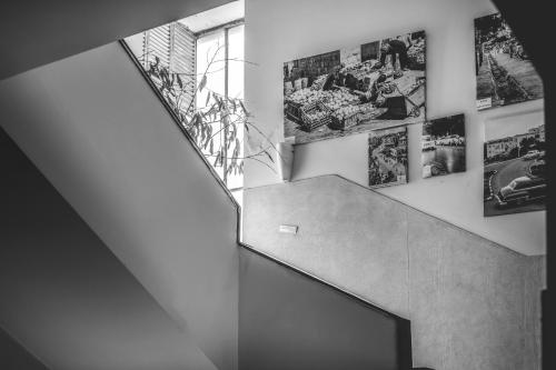 a staircase with pictures on the walls of a house at Satori Hotel in Haifa