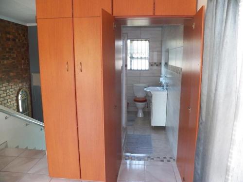 a bathroom with a toilet and a sink at 26 Pelser Plaat Meerensee in Richards Bay