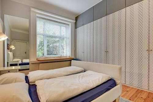 a bedroom with two beds and a window at Grand Apartments - Monte Cassino Blanco in Sopot