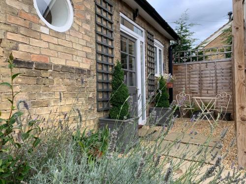 a brick house with a window and a door at The Grapevine Studio in Cambridge