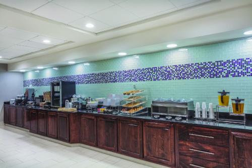 a restaurant kitchen with a counter with a buffet at La Quinta by Wyndham Columbus North in Columbus