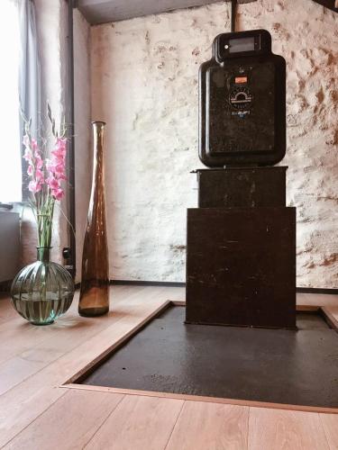 a camera sitting on top of a table next to vases at Fisher's Loft Hotel in Lübeck